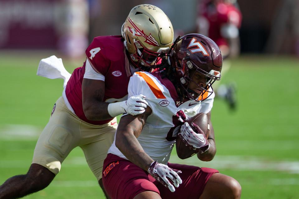 Florida State Seminoles linebacker Kalen DeLoach (4) takes down an opponent. The Florida State Seminoles lead the Virginia Tech Hokies 22-10 at the half on Saturday, Oct. 7, 2023.