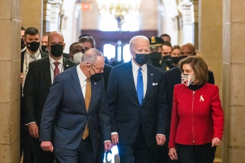 Senate Majority Leader Chuck Schumer and Speaker of the House Nancy Pelosi walk with President Joe Biden