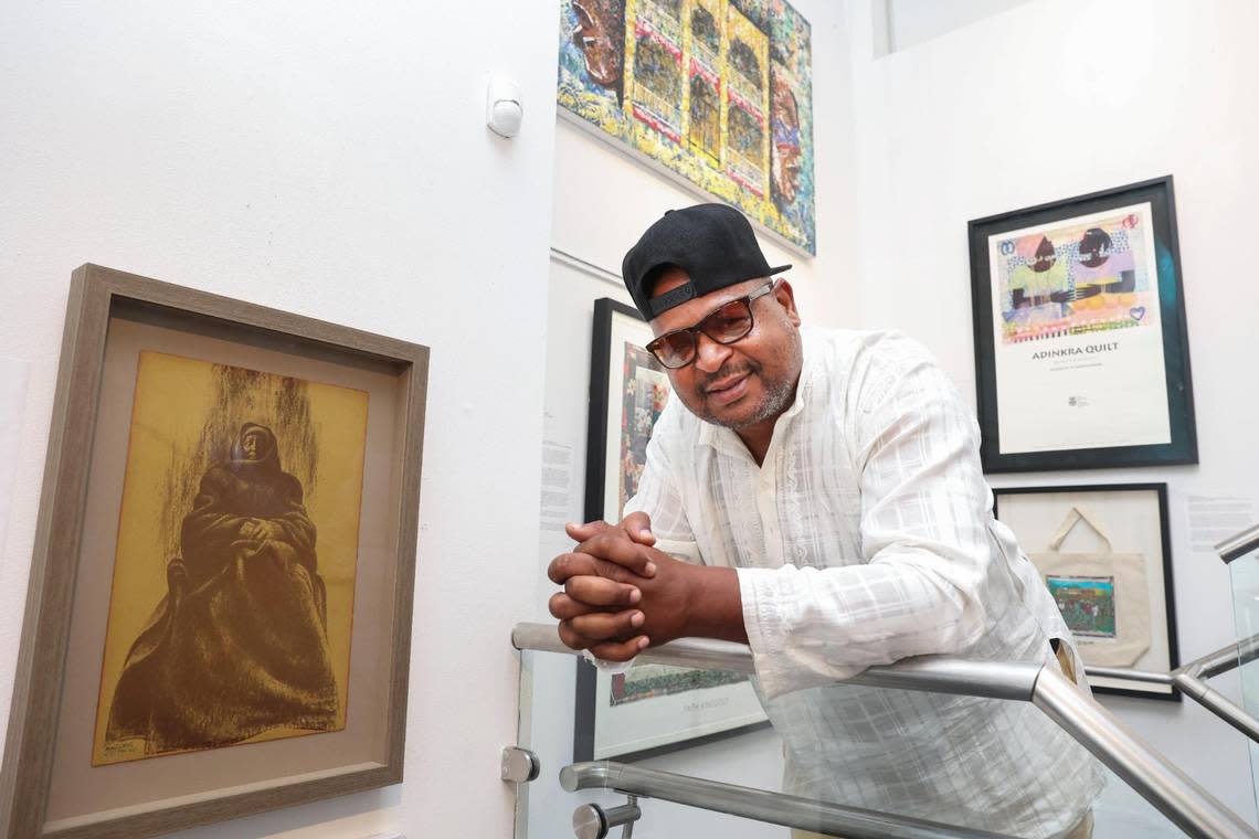 Curator Chris Norwood poses next to a piece by Charles White in Norwood’s gallery housed inside the Historic Ward Rooming House in Overtown on Sept. 15, 2022. ‘Most of this art is my personal art,’ said Norwood.