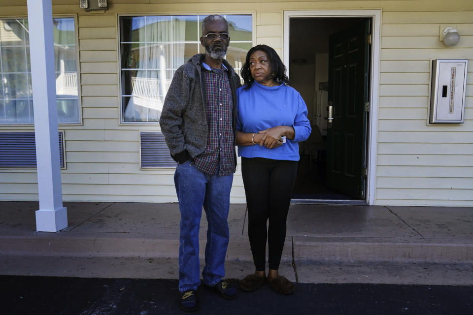 Faye Moore and her partner Garry Betared pose for a portrait outside a hotel room they are staying in following their eviction from Moore's two-bedroom townhouse on Wednesday, Nov. 24, 2021, in Morrow, Ga. Housing advocates say evictions are increasing around the country, several months after a federal moratorium was allowed to end. (AP Photo/Brynn Anderson)