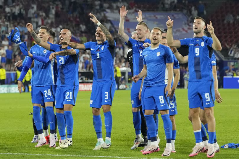 Slovenian players celebrate reaching first Euros qualification after a 0-0 draw against England