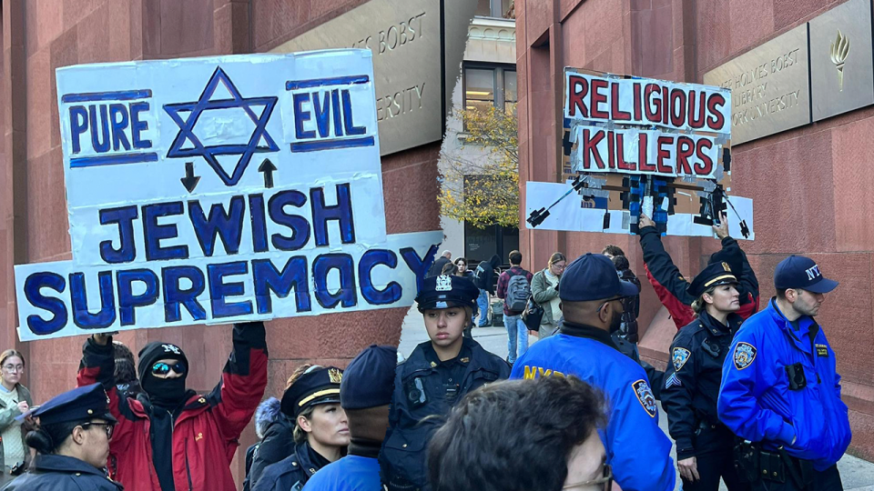 NYU protester Jewish supremacy sign