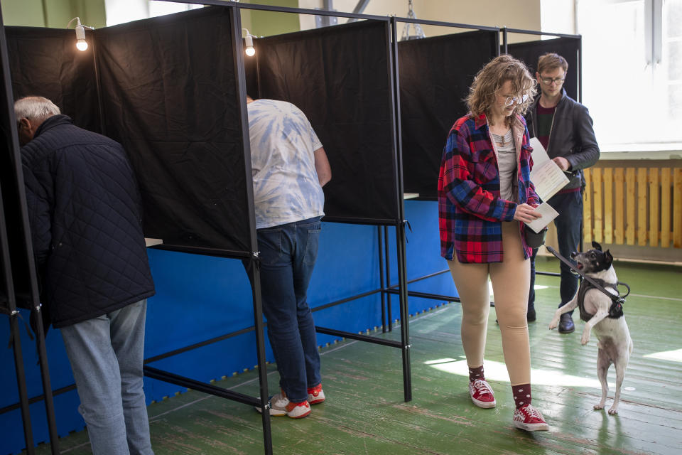 A woman walks to cast their ballots at a polling station during the first round of voting in presidential elections in Vilnius, Lithuania, Sunday, May 12, 2024. (AP Photo/Mindaugas Kulbis)