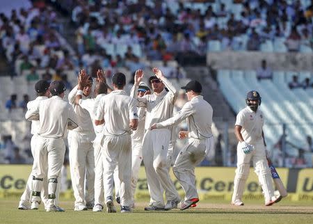 Cricket - India v New Zealand - Second Test cricket match - Eden Gardens, Kolkata, India - 30/09/2016. New Zealand's players celebrate the dismissal of India's Rohit Sharma. REUTERS/Rupak De Chowdhuri