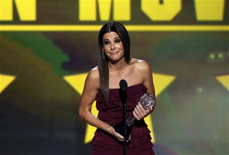 Sandra Bullock accepts the award for best actress in an action movie for "Gravity" at the 19th annual Critics' Choice Movie Awards in Santa Monica, California January 16, 2014. REUTERS/Mario Anzuoni