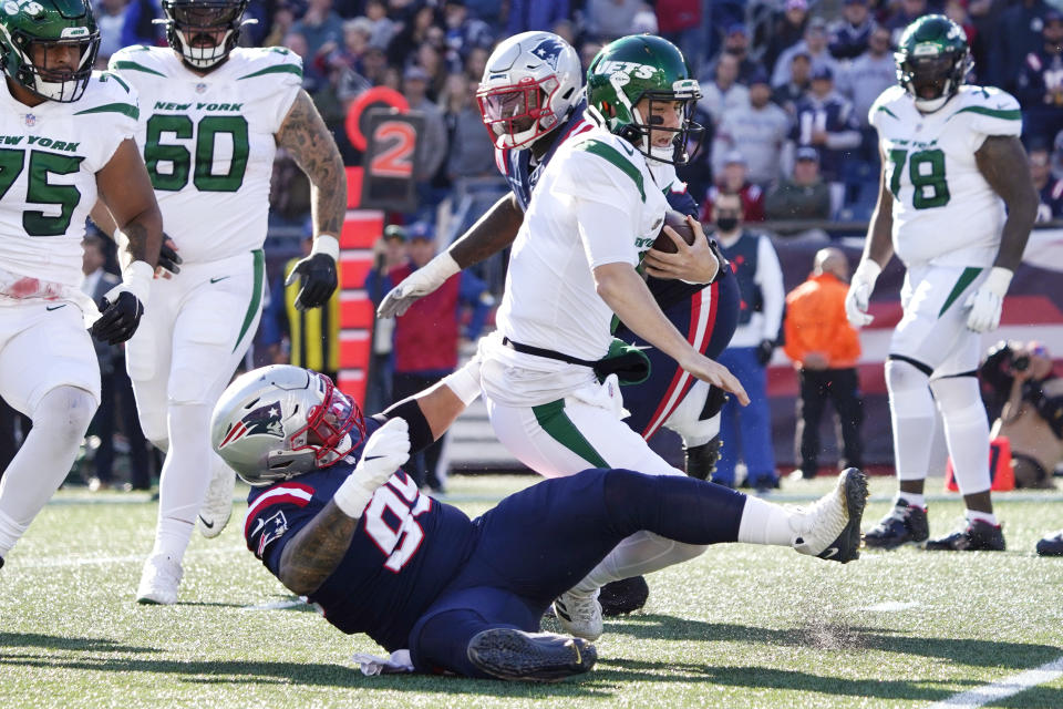 New York Jets quarterback Mike White is taken down by New England Patriots defensive lineman Daniel Ekuale (95) during the first half of an NFL football game, Sunday, Oct. 24, 2021, in Foxborough, Mass. (AP Photo/Mary Schwalm)