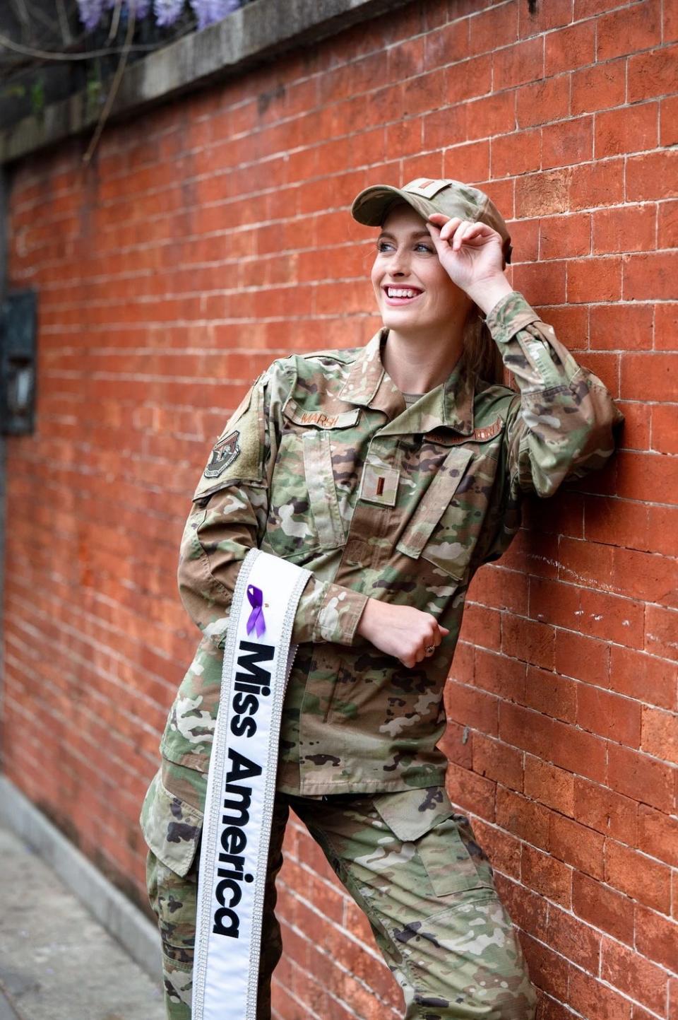 Second Lieutenant Madison Marsh wears her military uniform while holding her Miss America sash.