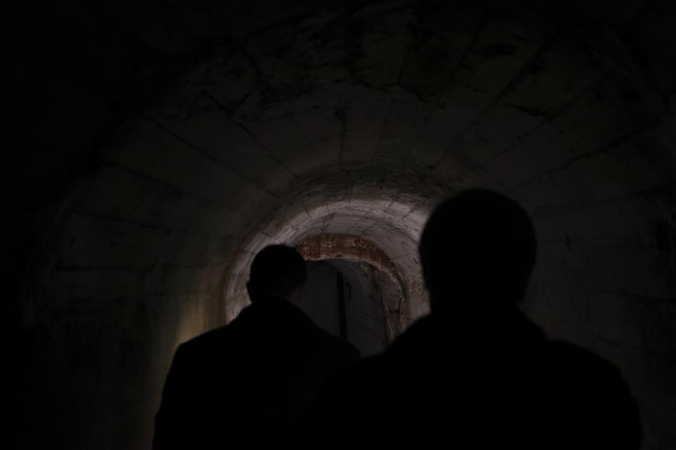 Bukurosh Onuzi, a tourist expert in charge of the museum project, shows the underground tunnels beneath the city of Kukes, about 150 kilometers (90 miles) north of Tirana, Albania, Wednesday, March 15, 2023. Authorities, assisted from the European Union, plan to rehabilitate the tunnel network and show to tourists how residents would live for six months in a similar town underneath. A spider network of 5-7 kilometer (3-4 mile) long tunnels could shelter 20,000-30,000 people. (AP Photo/Franc Zhurda)