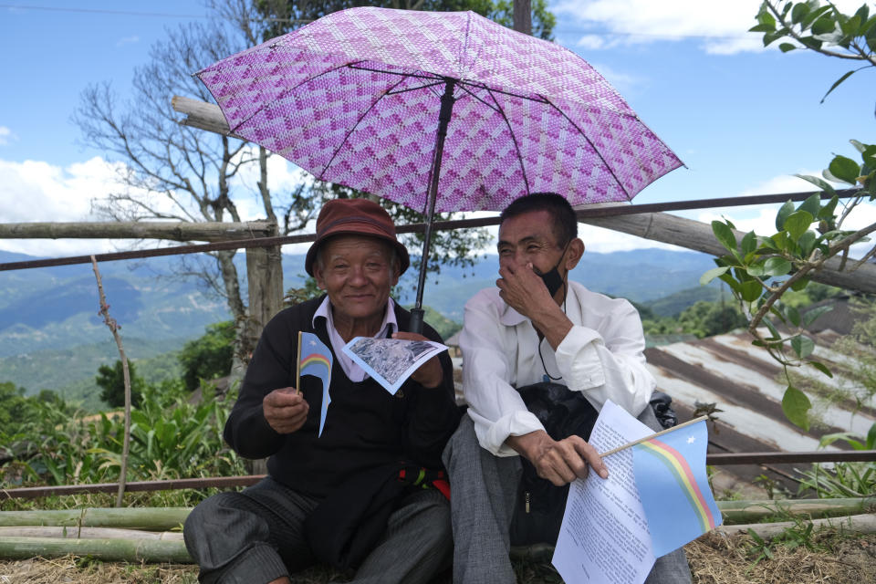 Elderly Nagas hold the Naga flag and join celebrations marking their Declaration of Independence in Chedema, in the northeastern Indian state of Nagaland, Sunday, Aug. 14, 2022. The Nagas - an indigenous people inhabiting several northeastern Indian states and across the border in Myanmar - marked the 75th anniversary of their declaration of independence on Sunday. (AP Photo/Yirmiyan Arthur)