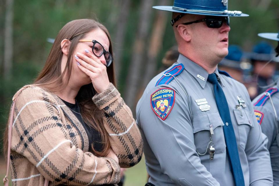 Mourners react as Bay St. Louis Capt. Rachel Jewell calls in the last radio call at the gravesite of Bay St. Louis police officers Sgt. Steven Robin and Branden Estorffe at Gardens of Memory cemetery in Bay St. Louis on Wednesday, Dec. 21, 2022. Robin and Estorffe were killed responding to a call at a Motel 6 on Dec. 14.