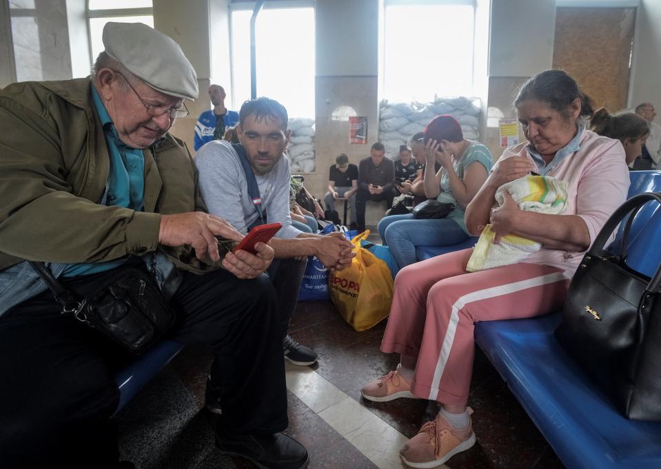 Local residents wait for an evacuation train (REUTERS)