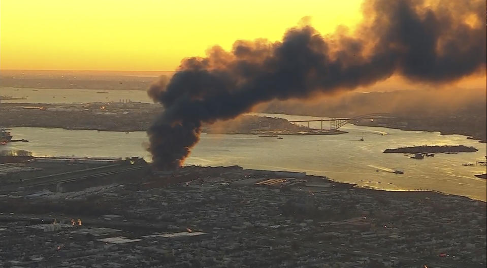 Smoke fills the sky from a fire in Elizabeth, NJ. Firefighters were battling a three-alarm fire at a New Jersey industrial park early Friday, a city official said. (WABC via AP)