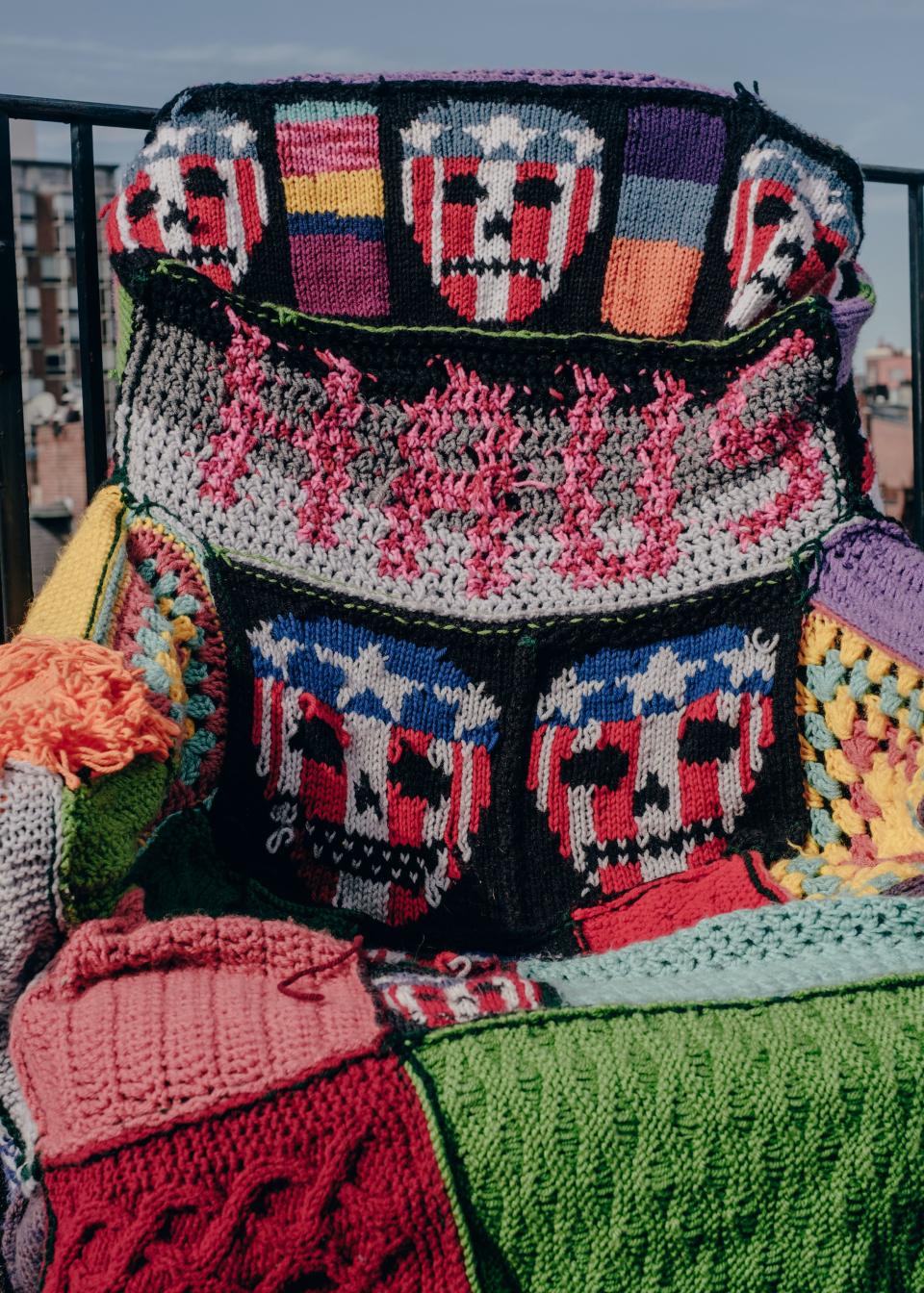 A knit chair cover adorned with the house's signature symbol, the skull.