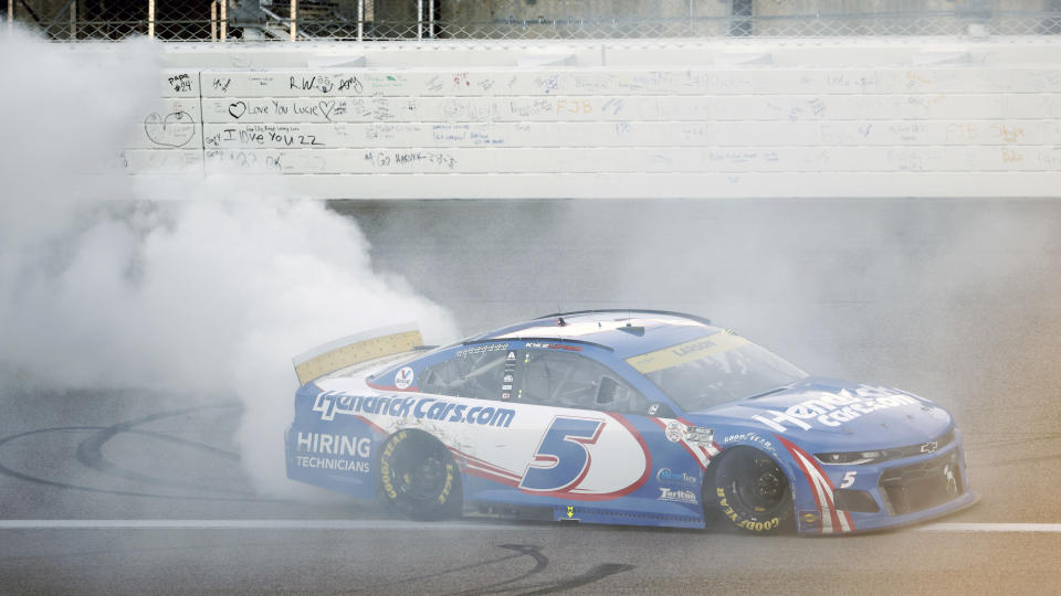 Kyle Larson (5) does a burnout after winning a NASCAR Cup Series auto race at Kansas Speedway in Kansas City, Kan., Sunday, Oct. 24, 2021. (AP Photo/Colin E. Braley)