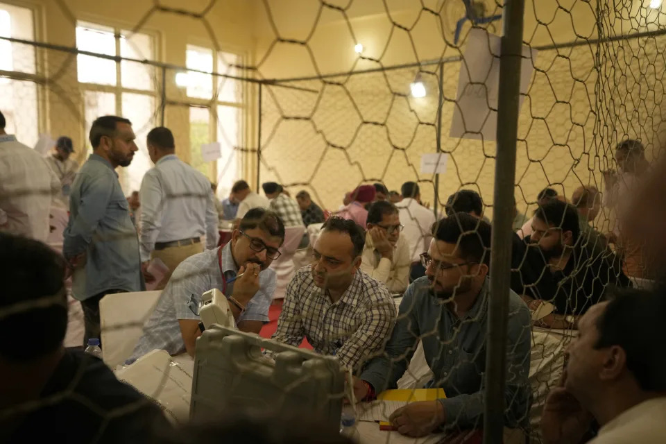 Election officers count votes for the recent election at a counting center in Jammu, India, Tuesday, Oct. 8, 2024. (AP Photo/Channi Anand)