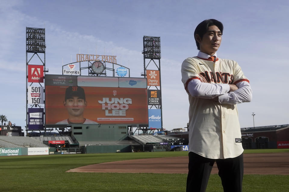 San Francisco Giants' Jung Hoo Lee poses for photos on the Oracle Park field after a baseball news conference in San Francisco, Friday, Dec. 15, 2023. (AP Photo/Jeff Chiu)