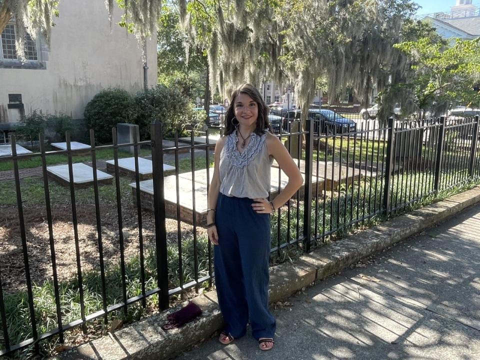 Rebekah Carmichael, a local medium known on social media as Rebekah the Ghost Guide, in front of the cemetery at St. James Episcopal Parish in Wilmington, N.C. She has amassed a large online following by chronicling her encounters with ghosts on TikTok and Instagram.