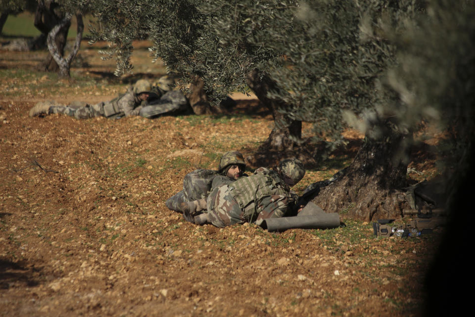 Turkish backed rebel fighters take positions near the village of Neirab in Idlib province, Syria, Thursday, Feb. 20, 2020. Two Turkish soldiers were killed Thursday by an airstrike in northwestern Syria, according to Turkey's Defense Ministry, following a large-scale attack by Ankara-backed opposition forces that targeted Syrian government troops. (AP Photo/Ghaith Alsayed)