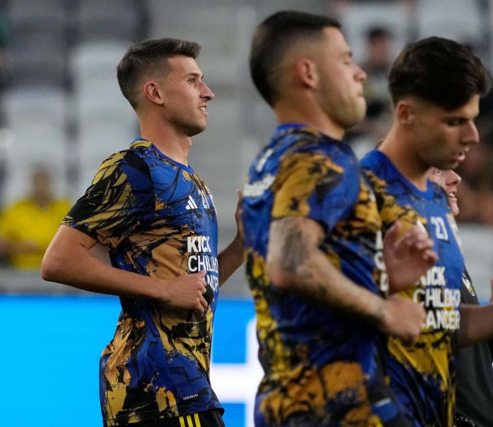 Crew defender Yevhen Cheberko participates in warmups before a match against Philadelphia.