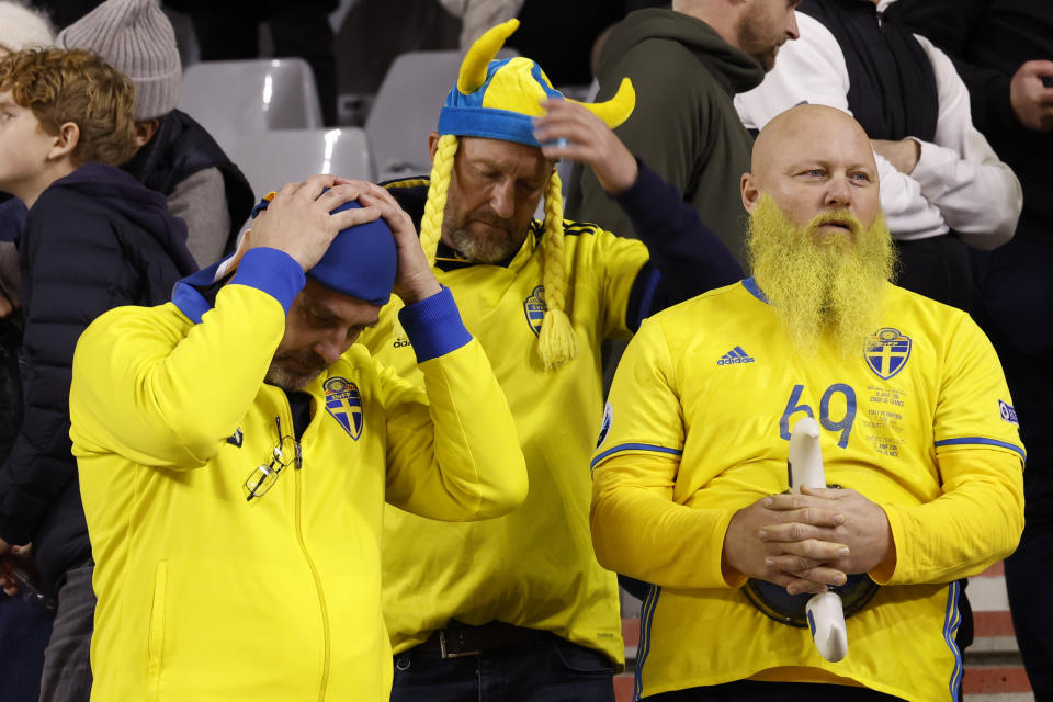 Sweden supporters wait on the stands after suspension of the Euro 2024 group F qualifying soccer match between Belgium and Sweden at the King Baudouin Stadium in Brussels, Monday, Oct. 16, 2023. The match was abandoned at halftime after two Swedes were killed in a shooting in central Brussels before kickoff. (AP Photo/Geert Vanden Wijngaert)