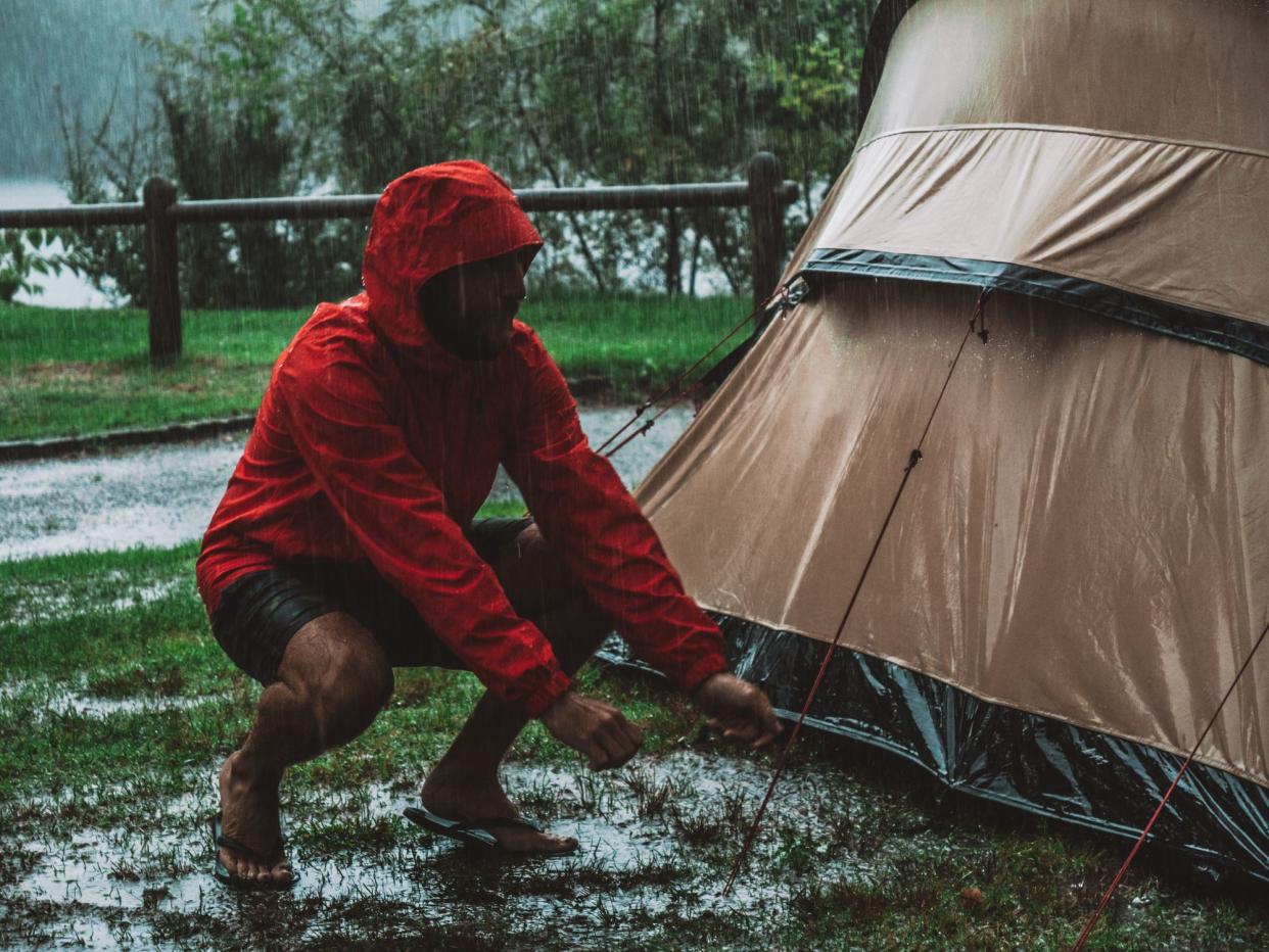 Man camping on rainy day