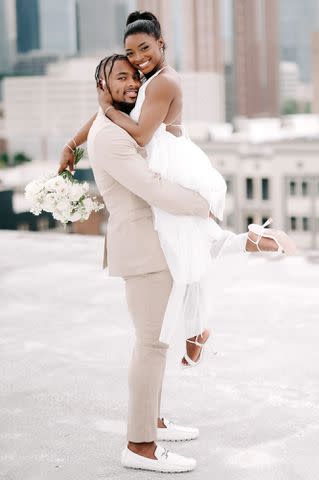 RAETAY PHOTOGRAPHY Jonathan Owens lifting wife Simone Biles for their wedding day photoshoot in April 2023.