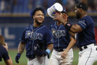 Tampa Bay Rays' Harold Ramirez, left, tosses an empty gum container to Yandy Diaz after the team's win over the Pittsburgh Pirates in 10 innings in a baseball game Friday, June 24, 2022, in St. Petersburg, Fla. (AP Photo/Scott Audette)