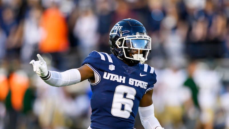 Utah State safety Ike Larsen (6) motions to teammates on defense during an NCAA football game on Saturday, Oct. 7, 2023 in Logan, Utah.