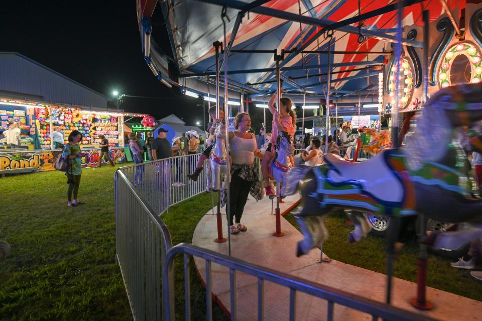 Fairgoers enjoying the carousel at the annual Big Knob Fair Tuesday in New Sewickley Township.