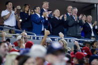 President Donald Trump, accompanied by first lady Melania Trump, second from left, and Republican lawmakers, stand during a Salute to the Military during Game 5 of a baseball World Series game between the Houston Astros and the Washington Nationals at Nationals Park in Washington, Sunday, Oct. 27, 2019. Also Pictured are Rep. John Ratcliffe, R-Texas, third from left, Sen. Lindsey Graham, R-S.C., right, Sen. David Perdue, R-Ga., fourth from right, and Rep. Mark Meadows, R-N.C., third from right. (AP Photo/Andrew Harnik)
