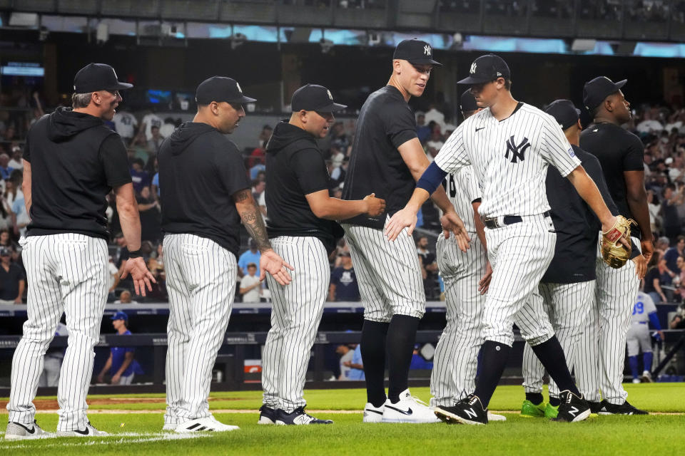 New York Yankees' Aaron Judge, fourth from left, congratulates DJ LeMahieu, front right, after the team defeated the Kansas City Royals in a baseball game, Friday, July 21, 2023, in New York. (AP Photo/Mary Altaffer)