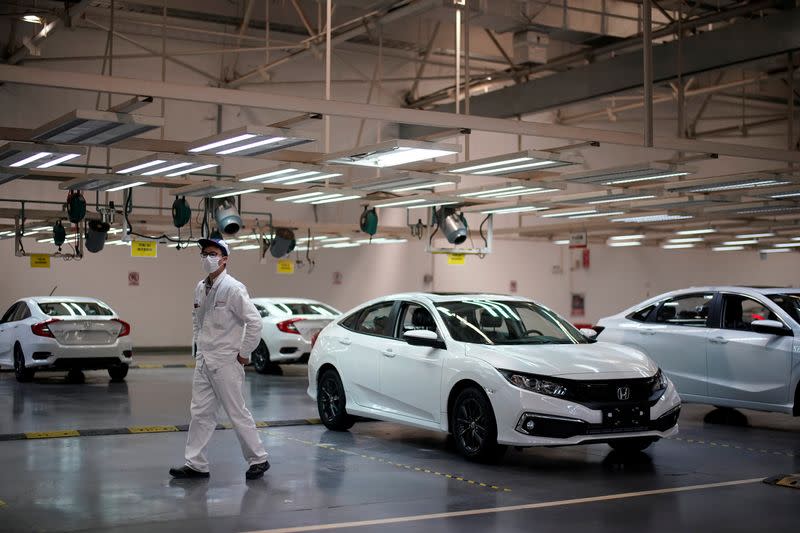 Employee is seen on a production line inside a Dongfeng Honda factory in Wuhan