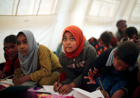 Displaced Iraqi children attend a class in a tent school set by United Nations Children's Fund (UNICEF) at Hassan Sham camp, east of Mosul, Iraq December 8, 2016. REUTERS/Mohammed Salem