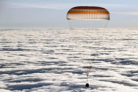 The Soyuz MS-06 capsule carrying the crew of Joe Acaba and Mark Vande Hei of the U.S., and Alexander Misurkin of Russia descends beneath a parachute just before landing in a remote area outside the town of Dzhezkazgan (Zhezkazgan), Kazakhstan, February 28, 2018. REUTERS/Alexander Nemenov/Pool