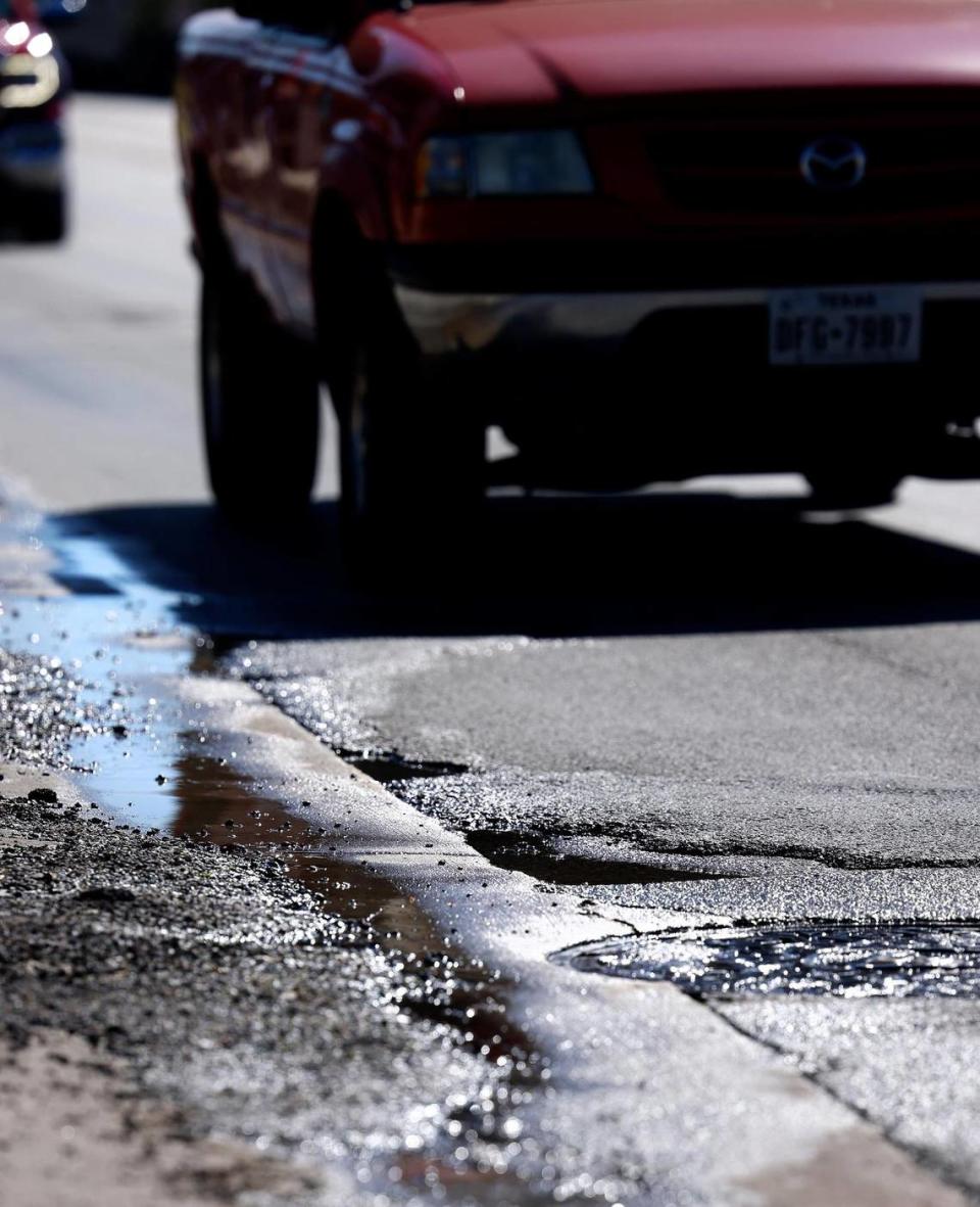 Vehicles pass potholes while driving north on 8th Street in Fort Worth on Tuesday, February 21, 2024.