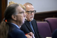 Greg McMichael. center, listens to jury selection for the trial of he and his son Travis McMichael and William "Roddie" Bryan, at the Glynn County Courthouse, Monday, Oct. 25, 2021, in Brunswick, Ga. The trio are charged with the slaying of 25-year-old Ahmaud Arbery in February 2020. (AP Photo/Stephen B. Morton, Pool)