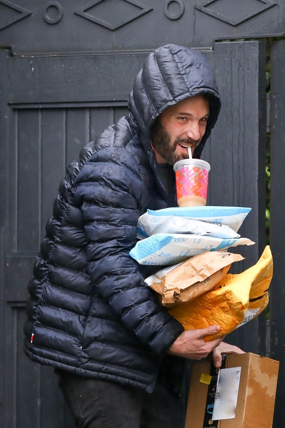 Ben Affleck balances his mail and Dunkin' Donuts. (Backgrid)