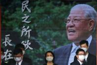 Staff wear face masks to prevent the spread of the coronavirus disease ( COVID-19) at the entrance of late Taiwanese President Lee Teng-hui memorial service in Taipei