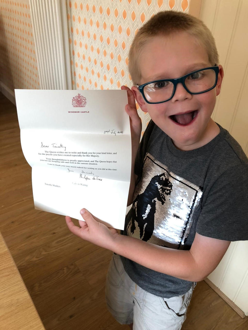 Seven-year-old Timothy Madders of Billericay in Essex with the reply he received from Windsor Castle thanking him for his thoughtfulness after he sent the Queen a word search that he made in case she felt sad or lonely during lockdown.