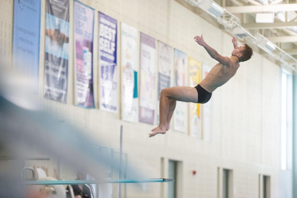 Topeka High sophomore diver Jaxon Cowdin leaps to perform a back 2 summersault tuck at Tuesday's Topeka West Invitational at Capitol Federal Natatorium.