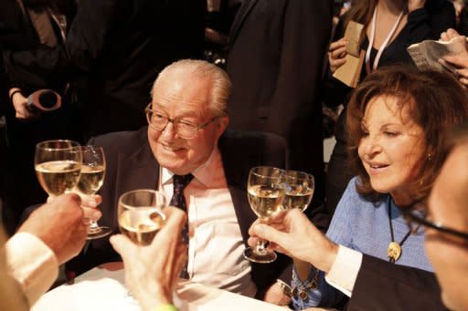 European MP and former leader of French far right party Front National (FN) Jean-Marie Le Pen (L) and his wife Jany share a toast with supporters during the Election night rally of his party to support FN's candidate Marine Le Pen on the evening of the first round of the 2012 French Presidential election in Paris. Far-right candidate Marine Le Pen won 18.2 to 20 percent in Sunday's first-round