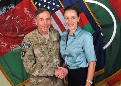 David Petraeus shakes hands with his biographer Paula Broadwell in Afghanistan in this 2011 image provide by International Security Assistance Force NATO. The FBI uncovered the affair that led to the resignation of Petraeus while investigating threatening emails sent by his lover to a second woman, US media reported Sunday