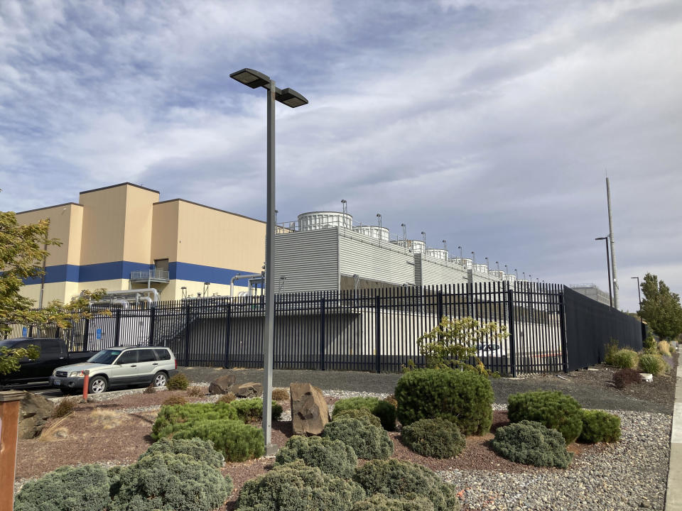 FILE - The exterior of a Google data center is pictured in The Dalles, Ore., on Oct. 5, 2021. Residents of The Dalles should soon know how much of their water Google's data centers there have been using to cool the computers, after a lawsuit seeking to keep the information confidential was dropped. Data centers around the world help people stream movies, store trillions of photos and conduct daily business online, but a single facility can churn through millions of gallons of water per day. (AP Photo/Andrew Selsky, File)