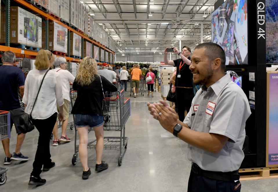 Brian Reyes, tire center manager, welcomes the first customers at Costco Wholesale in Jackson Township.
