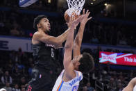 Houston Rockets forward Kenyon Martin Jr. (6) shoots over Oklahoma City Thunder forward Jeremiah Robinson-Earl (50) during the first half of an NBA basketball game Wednesday, Dec. 1, 2021, in Oklahoma City. (AP Photo/Sue Ogrocki)