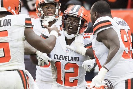 FILE PHOTO: Sep 9, 2018; Cleveland, OH, USA; Cleveland Browns wide receiver Josh Gordon (12) celebrates with quarterback Tyrod Taylor (5) and defensive tackle Devaroe Lawrence (99) after catching a touchdown during the fourth quarter at FirstEnergy Stadium. Mandatory Credit: Ken Blaze-USA TODAY Sports/File Photo