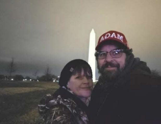 Christy and Matthew Clark of Pennsylvania posed for a photo in front of the Washington monument. They're among those charged by federal authorities for their participation in the Capitol riot.