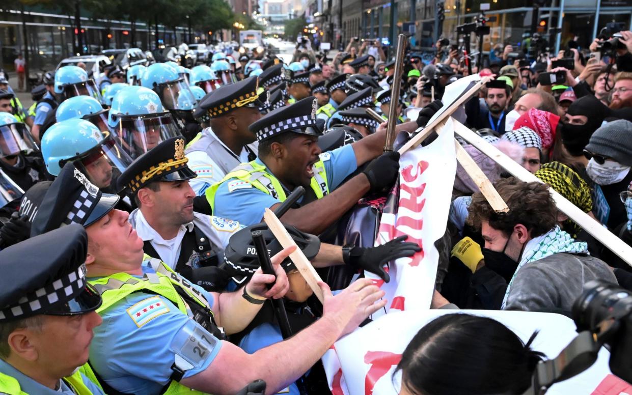 Demonstrators clash with police near the Israeli Consulate during the second day of the DNC