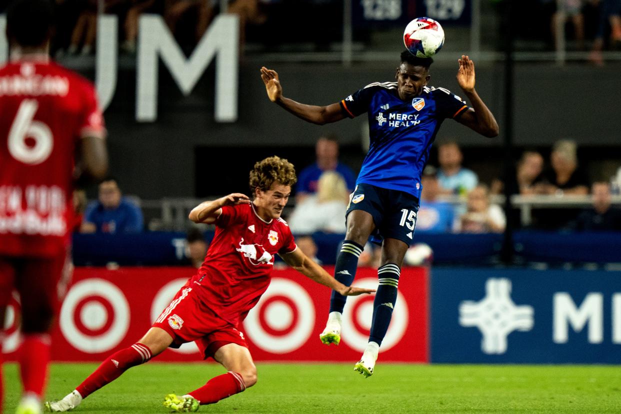 New York Red Bulls forward Tom Barlow (74) defends as FC Cincinnati defender Yerson Mosquera (15) heads the ball in the first half of the MLS match between FC Cincinnati and New York Red Bulls at TQL Stadium in Cincinnati on Wednesday, Oct. 4, 2023.