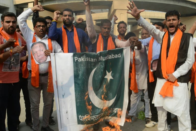 Members of the Shiv Sena nationalist Hindu group shout slogans as they burn a Pakistani flag during a protest against Pakistan, in Amritsar on September 19, 2016